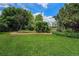 Spacious backyard with a lush green lawn and mature landscaping, perfect for outdoor enjoyment and entertaining at 1010 Home Farm Cir, Denver, CO 80234