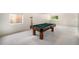 Inviting basement with a well-lit billiard table, providing a perfect leisure space in the home at 1010 Home Farm Cir, Denver, CO 80234