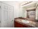 Stylish bathroom featuring a vanity with a tiled countertop and a walk-in shower with glass doors at 1010 Home Farm Cir, Denver, CO 80234