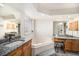 Bathroom with dual vanity, soaking tub, and glass block window at 1010 Home Farm Cir, Denver, CO 80234