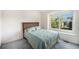 Bedroom features a large window with views of mature trees at 1010 Home Farm Cir, Denver, CO 80234