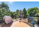 Outdoor deck furnished with a dining table, grill, and lush greenery, perfect for relaxing and entertaining at 1010 Home Farm Cir, Denver, CO 80234
