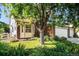 Beautiful landscaping surrounds this home, featuring mature trees and colorful flowerbeds at 1010 Home Farm Cir, Denver, CO 80234