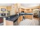 Modern kitchen with stainless steel appliances, granite counters, and bright, tile flooring at 1010 Home Farm Cir, Denver, CO 80234