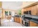 Updated kitchen with stainless steel appliances, ample counter space, and adjacent breakfast nook at 1010 Home Farm Cir, Denver, CO 80234
