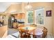 Eat-in kitchen features stainless appliances, tile floors, and natural light at 1010 Home Farm Cir, Denver, CO 80234