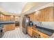 Well-lit kitchen featuring wooden cabinets, stainless steel appliances, and built-in workspace at 1010 Home Farm Cir, Denver, CO 80234