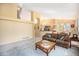 Open living area features high ceilings, large windows, and neutral carpeting at 1010 Home Farm Cir, Denver, CO 80234
