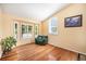 Bright living room featuring hardwood floors, large windows, and comfortable seating at 1010 Home Farm Cir, Denver, CO 80234