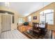 Open-concept space with living and dining areas, hardwood floors, and arch window at 1010 Home Farm Cir, Denver, CO 80234