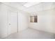 Bright room with a closet door and a window, featuring carpeted floors at 1010 Home Farm Cir, Denver, CO 80234