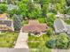 Aerial view of the brick home with lush landscaping, nearby gazebo, water feature and solar panels at 1160 Johnson St, Lakewood, CO 80215