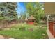 Beautiful backyard featuring a tranquil gazebo and mature trees at 1160 Johnson St, Lakewood, CO 80215