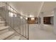 Finished basement with a decorative metal railing, wood paneled walls, and a brick fireplace focal point at 1160 Johnson St, Lakewood, CO 80215