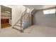 Basement with a carpeted staircase, wood paneled walls, a window with curtains, and access to another room at 1160 Johnson St, Lakewood, CO 80215