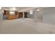 Spacious finished basement with carpeting, exposed support beams, a brick fireplace, and a custom-built wooden bar at 1160 Johnson St, Lakewood, CO 80215