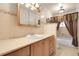 Cozy bathroom featuring a single sink vanity, tiled countertop, and a framed medicine cabinet at 1160 Johnson St, Lakewood, CO 80215
