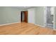 Bright bedroom with light green walls, hardwood floors, and access to an attached bathroom with glass enclosed shower at 1160 Johnson St, Lakewood, CO 80215