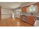 Well-lit kitchen with hardwood floors, stainless steel appliances, modern countertops and window lighting at 1160 Johnson St, Lakewood, CO 80215
