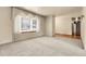 Expansive living room with plush carpeting and an abundance of natural light through large windows at 1160 Johnson St, Lakewood, CO 80215