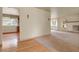 Spacious living room with a glimpse of the kitchen, featuring elegant lighting and neutral colors at 1160 Johnson St, Lakewood, CO 80215