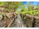 Charming backyard with wooden encased water feature leading to hidden stream at 1160 Johnson St, Lakewood, CO 80215