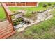 Charming backyard featuring a rock lined water feature and wooden bridge surrounded by lush greenery at 1160 Johnson St, Lakewood, CO 80215