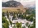 Aerial view of house among trees at 9034 Us Highway 285, Morrison, CO 80465