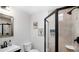 Neutral bathroom featuring a glass shower, modern vanity, and decorative wall art at 9034 Us Highway 285, Morrison, CO 80465