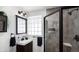 Modern bathroom featuring a glass block window and shower with sleek, black hardware at 9034 Us Highway 285, Morrison, CO 80465