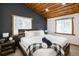 Vaulted bedroom showcasing exposed wood beam ceilings, neutral decor, and ample natural light at 9034 Us Highway 285, Morrison, CO 80465