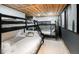 Cozy bedroom featuring two bunkbeds with a rustic wooden ceiling and modern decor at 9034 Us Highway 285, Morrison, CO 80465