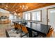 Contemporary dining room with a wood ceiling, modern lighting, access to the kitchen, and bright natural light at 9034 Us Highway 285, Morrison, CO 80465