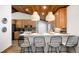 Kitchen island with bar stool seating and decorative backsplash at 9034 Us Highway 285, Morrison, CO 80465