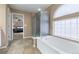 Spa-like bathroom with soaking tub, shower, and views into bedroom at 4686 Longs Ct, Broomfield, CO 80023