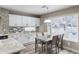 Bright dining area with table and chairs near kitchen and window at 4686 Longs Ct, Broomfield, CO 80023