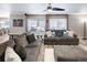 Comfortable living room featuring a gray sectional sofa and ceiling fan at 4686 Longs Ct, Broomfield, CO 80023