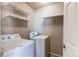 Laundry room with washer, dryer, and shelving at 12754 Jasmine St # A, Thornton, CO 80602