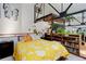 Comfortable bedroom featuring book shelves, an industrial ceiling with beams, and decorative house plants at 3377 Blake St # 205, Denver, CO 80205