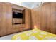 Comfortable bedroom features built in wooden closets and media center with television and bright yellow comforter at 3377 Blake St # 205, Denver, CO 80205