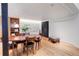 Bright dining room with wood floors, large table, and modern accents at 3377 Blake St # 205, Denver, CO 80205