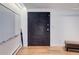 Hallway featuring a unique chalkboard door and hardwood flooring at 3377 Blake St # 205, Denver, CO 80205