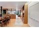 Inviting living area with open floor plan to the kitchen and wood floors throughout at 3377 Blake St # 205, Denver, CO 80205