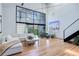 Bright, open living room with soaring ceilings, large windows, and hardwood floors at 3377 Blake St # 205, Denver, CO 80205
