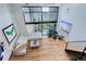 Bright living space with high ceilings and large windows. Features stylish furniture and hardwood floors at 3377 Blake St # 205, Denver, CO 80205