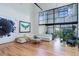 Bright living space with high ceilings and large windows. Features stylish furniture and hardwood floors at 3377 Blake St # 205, Denver, CO 80205