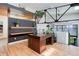 Modern office space with hardwood floors, built-in shelving, and a large desk with natural light at 3377 Blake St # 205, Denver, CO 80205
