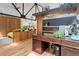 Home office space featuring dark wood desk, hardwood floors, and bright lighting from skylight at 3377 Blake St # 205, Denver, CO 80205