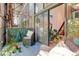 Covered patio area with seating and lush plants, leading to an interior view at 3377 Blake St # 205, Denver, CO 80205