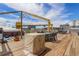 Spacious rooftop deck featuring a table and chairs for outdoor dining and views of the city at 3377 Blake St # 205, Denver, CO 80205